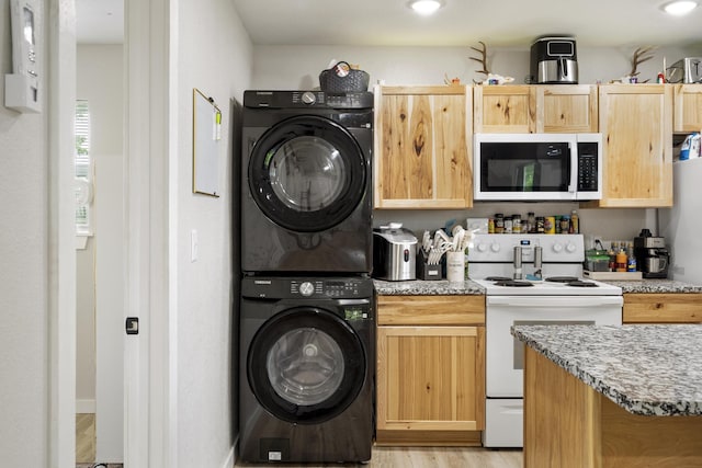 166 Seaman St, Cape Fair, MO 65624 - kitchen featuring electric range, stacked washer / drying machine, light brown cabinetry, light wood finished floors, and light stone countertops
