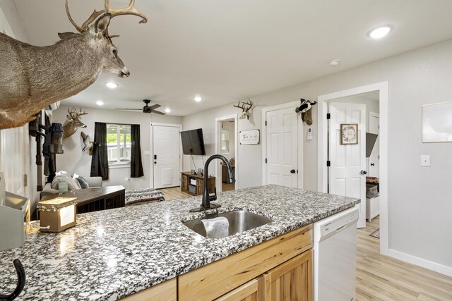 166 Seaman St, Cape Fair, MO 65624 - kitchen with a sink, white dishwasher, light stone countertops, light wood-style floors, and ceiling fan