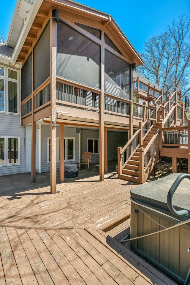 1915 S Farm Rd Unit 219, Springfield, MO 65809 - wooden terrace with a hot tub, a sunroom, and stairs