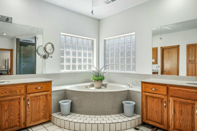 1915 S Farm Rd Unit 219, Springfield, MO 65809 - full bath featuring vanity, a garden tub, tile patterned flooring, a stall shower, and ceiling fan