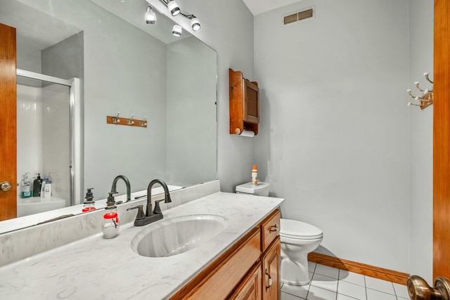 1915 S Farm Rd Unit 219, Springfield, MO 65809 - bathroom with tile patterned floors, an enclosed shower, vanity, toilet, and baseboards