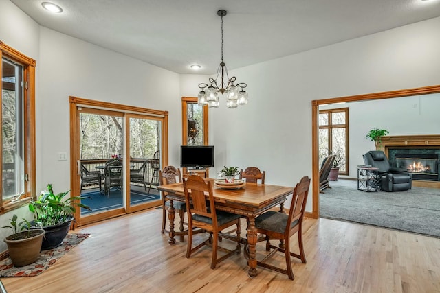 1915 S Farm Rd Unit 219, Springfield, MO 65809 - dining space with light wood-style flooring, a chandelier, a fireplace, and recessed lighting