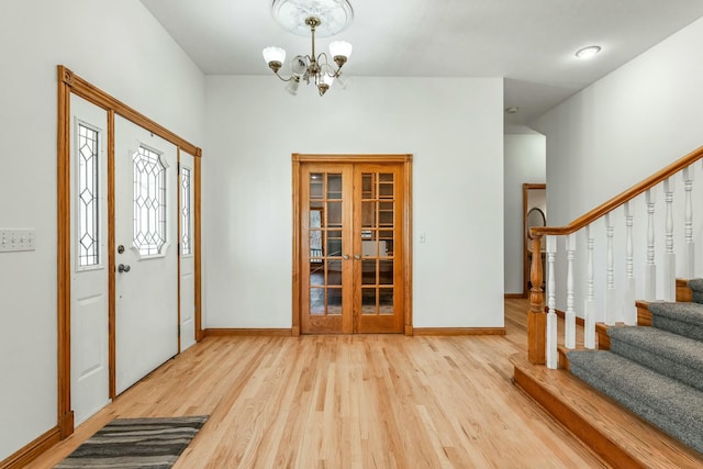 1915 S Farm Rd Unit 219, Springfield, MO 65809 - foyer entrance with wood finished floors, a chandelier, stairway, and baseboards