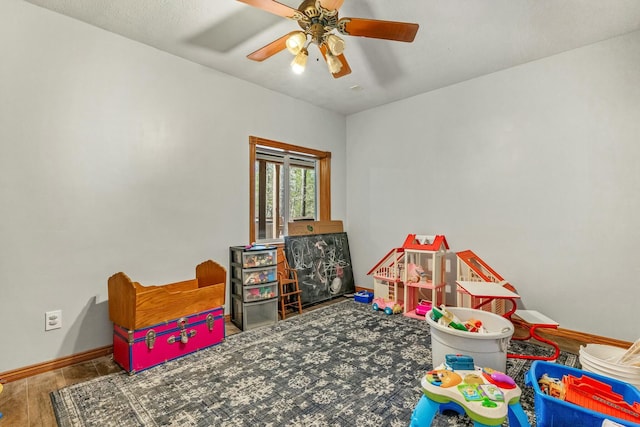 1915 S Farm Rd Unit 219, Springfield, MO 65809 - recreation room with baseboards, wood finished floors, and a ceiling fan