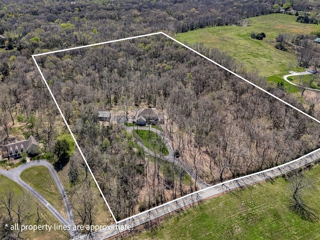 1915 S Farm Rd Unit 219, Springfield, MO 65809 - aerial overview of property's location featuring a heavily wooded area and property boundaries highlighted