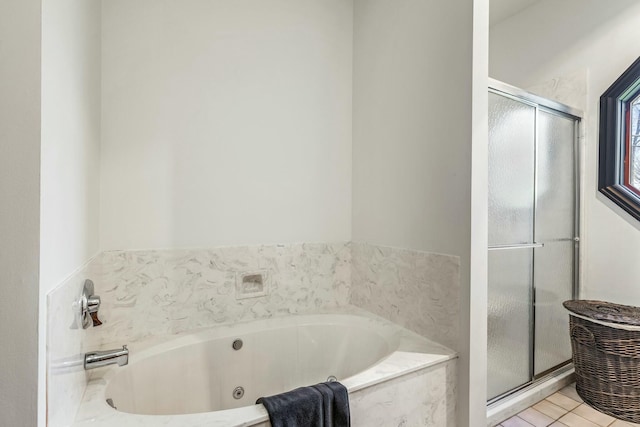 1915 S Farm Rd Unit 219, Springfield, MO 65809 - bathroom featuring a shower stall, a whirlpool tub, and tile patterned floors
