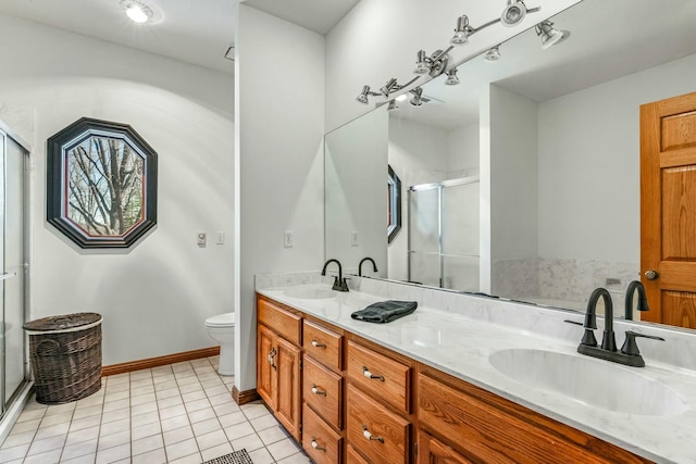 1915 S Farm Rd Unit 219, Springfield, MO 65809 - bathroom featuring a stall shower, double vanity, tile patterned floors, toilet, and baseboards