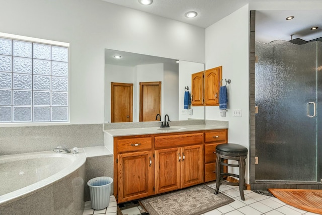 1915 S Farm Rd Unit 219, Springfield, MO 65809 - bathroom with a shower stall, tile patterned flooring, vanity, healthy amount of natural light, and recessed lighting