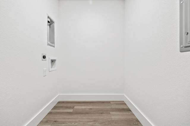 228 Vacation Ln Unit 2, Reeds Spring, MO 65737 - laundry room featuring electric dryer hookup, washer hookup, light wood-type flooring, and baseboards