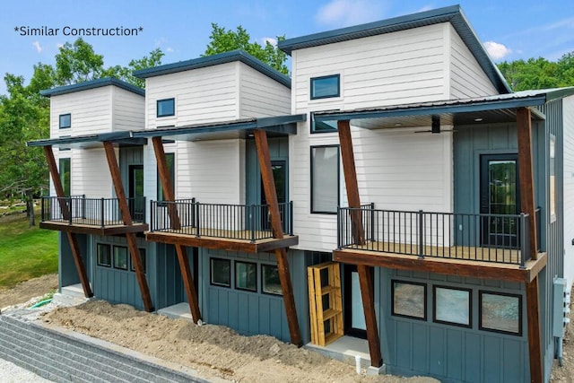 228 Vacation Ln Unit 2, Reeds Spring, MO 65737 - back of house with board and batten siding and a balcony