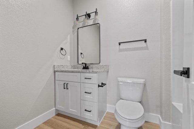 20 Teak Dr Unit 15, Reeds Spring, MO 65737 - bathroom featuring wood finished floors, vanity, toilet, and baseboards