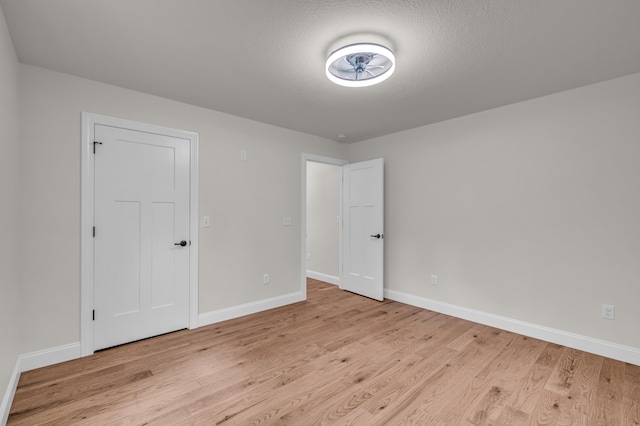 3002 Ginger Dr, West Plains, MO 65775 - unfurnished bedroom featuring baseboards and light wood finished floors