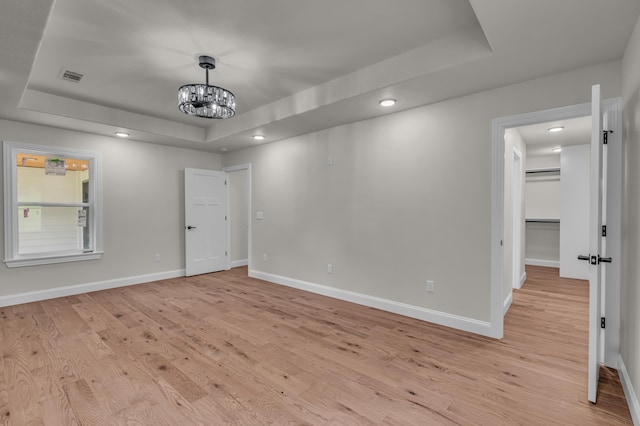 3002 Ginger Dr, West Plains, MO 65775 - empty room with a tray ceiling, baseboards, a chandelier, light wood-style floors, and recessed lighting