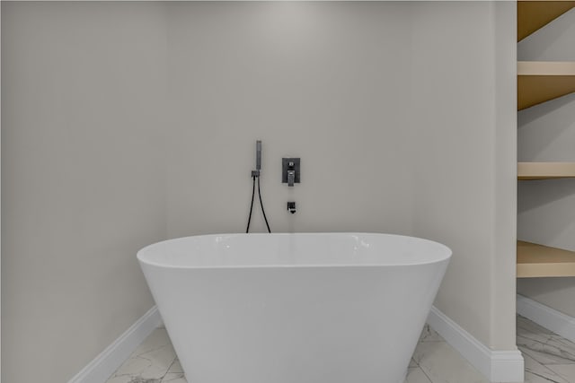 3002 Ginger Dr, West Plains, MO 65775 - full bathroom with marble look tile flooring, a freestanding bath, and baseboards