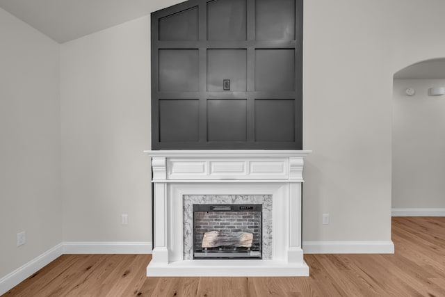 3002 Ginger Dr, West Plains, MO 65775 - detailed view of arched walkways, a fireplace, wood finished floors, and baseboards