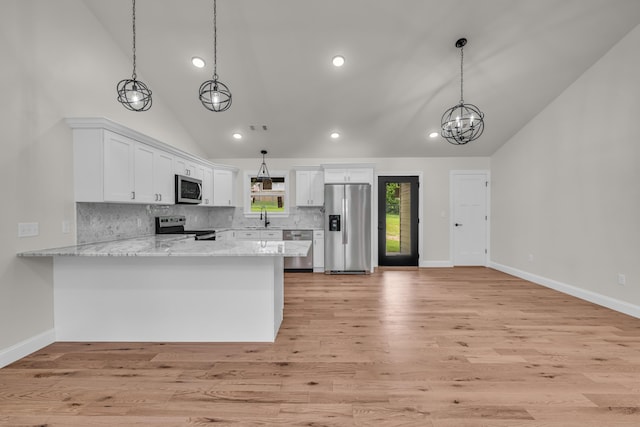 3002 Ginger Dr, West Plains, MO 65775 - kitchen featuring appliances with stainless steel finishes, a sink, white cabinetry, tasteful backsplash, and a peninsula
