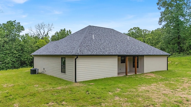 3002 Ginger Dr, West Plains, MO 65775 - back of house with roof with shingles, a yard, and cooling unit