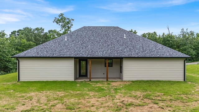 3002 Ginger Dr, West Plains, MO 65775 - rear view of house featuring roof with shingles, a patio, and a lawn