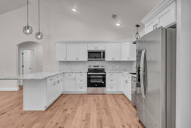 3002 Ginger Dr, West Plains, MO 65775 - kitchen with appliances with stainless steel finishes, a peninsula, arched walkways, white cabinetry, and light stone countertops