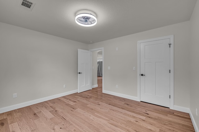 3002 Ginger Dr, West Plains, MO 65775 - unfurnished bedroom featuring light wood-style floors, baseboards, and freestanding refrigerator