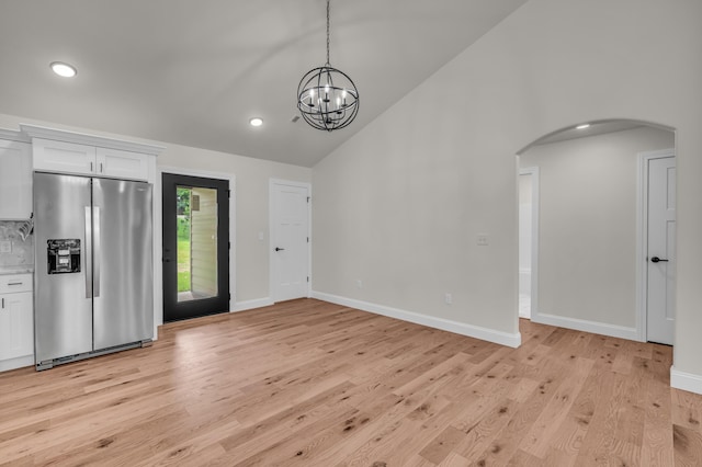 3002 Ginger Dr, West Plains, MO 65775 - unfurnished living room with arched walkways, light wood finished floors, recessed lighting, a chandelier, and baseboards