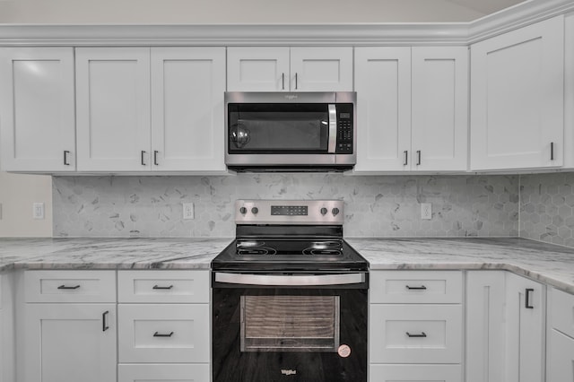 3002 Ginger Dr, West Plains, MO 65775 - kitchen with appliances with stainless steel finishes, white cabinets, and tasteful backsplash