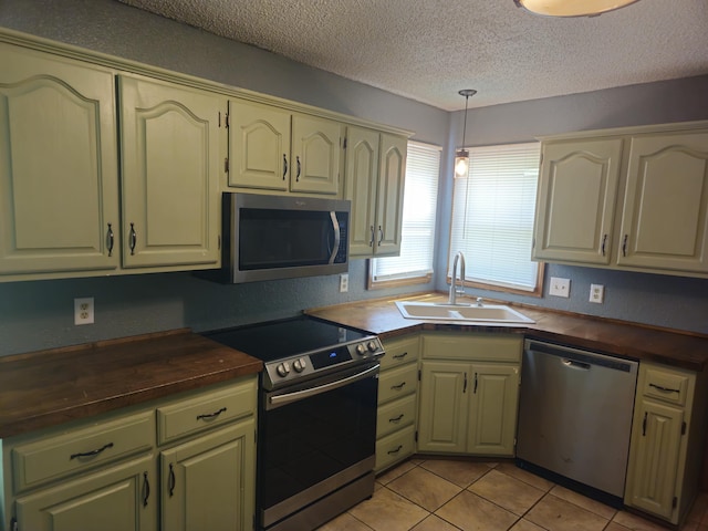 108 Prince St, Buffalo, MO 65622 - kitchen featuring appliances with stainless steel finishes, a sink, wood counters, a textured ceiling, and pendant lighting