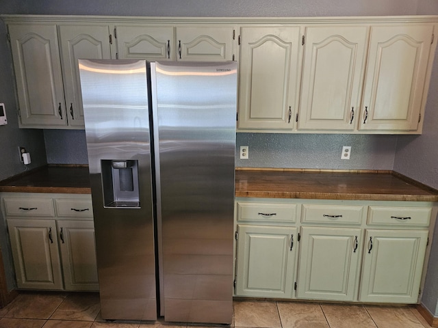 108 Prince St, Buffalo, MO 65622 - kitchen with stainless steel fridge with ice dispenser, dark countertops, and light tile patterned floors