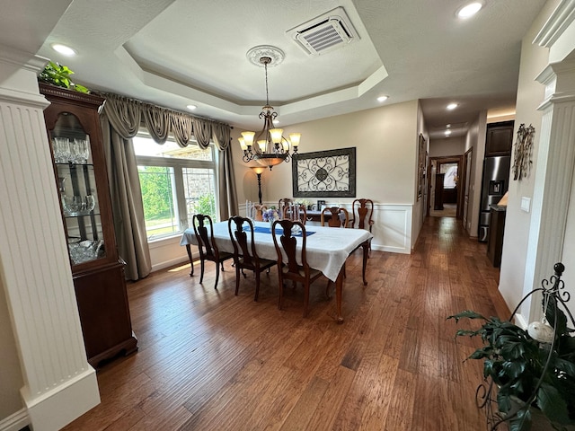 1762 Hickory Ridge Cir, Nixa, MO 65714 - dining room with a chandelier, a raised ceiling, dark wood-style flooring, a wainscoted wall, and recessed lighting