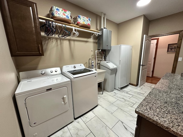 1762 Hickory Ridge Cir, Nixa, MO 65714 - laundry area featuring cabinet space, independent washer and dryer, light marble finish flooring, and tankless water heater