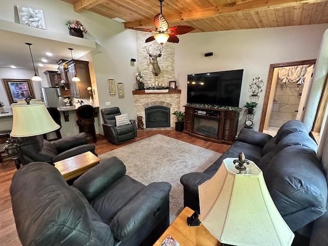 1762 Hickory Ridge Cir, Nixa, MO 65714 - living room featuring a stone fireplace, wood finished floors, a ceiling fan, and wood ceiling with exposed beams