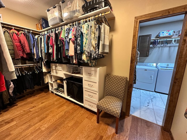 1762 Hickory Ridge Cir, Nixa, MO 65714 - walk in closet with washing machine and clothes dryer and light wood-type flooring