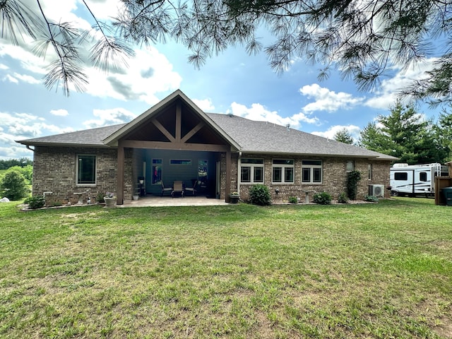 1762 Hickory Ridge Cir, Nixa, MO 65714 - back of house featuring brick siding, a lawn, a cooling unit, a patio, and roof with shingles