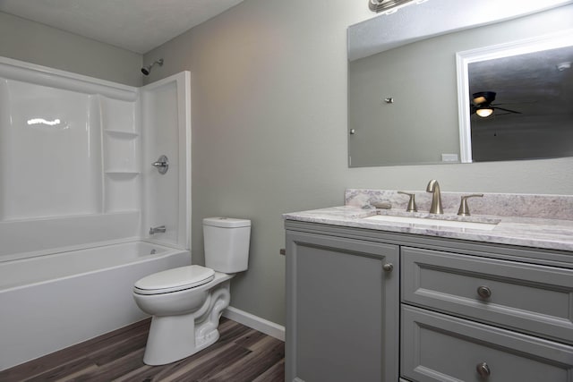 304 Rice St, Nixa, MO 65714 - bathroom with vanity, toilet, wood finished floors, a ceiling fan, and shower / bathtub combination