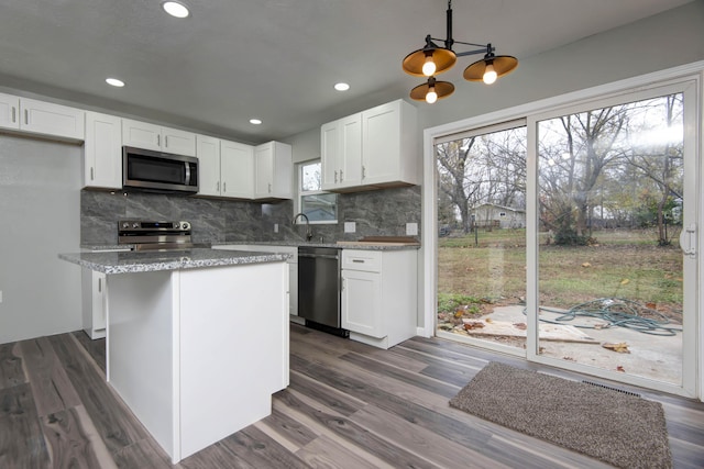 304 Rice St, Nixa, MO 65714 - kitchen with appliances with stainless steel finishes, white cabinetry, backsplash, and recessed lighting