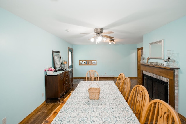 19429 E State Highway 14, Ava, MO 65608 - dining area with a fireplace, a ceiling fan, dark wood-style flooring, baseboards, and baseboard heating