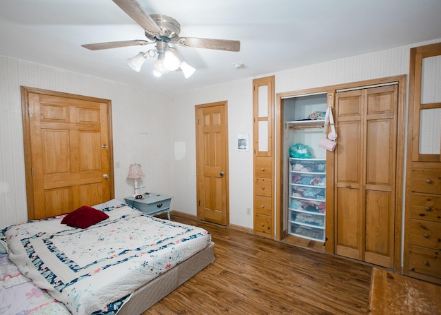 19429 E State Highway 14, Ava, MO 65608 - bedroom featuring wood finished floors, a closet, a ceiling fan, and wallpapered walls