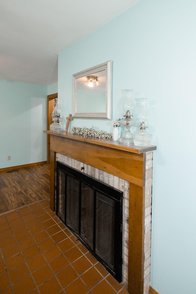 19429 E State Highway 14, Ava, MO 65608 - detailed view of a fireplace, baseboards, and wood finished floors