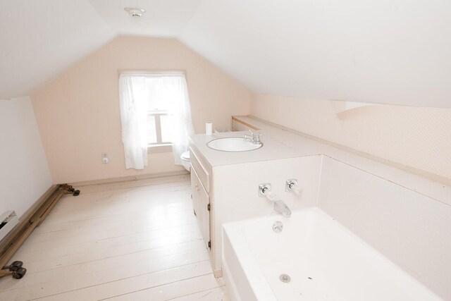 19429 E State Highway 14, Ava, MO 65608 - bathroom with a jetted tub, lofted ceiling, toilet, wood finished floors, and vanity
