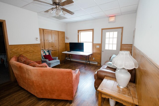 19429 E State Highway 14, Ava, MO 65608 - living room with a paneled ceiling, a baseboard radiator, wainscoting, wood finished floors, and a ceiling fan