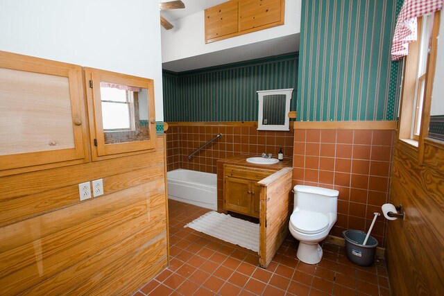 19429 E State Highway 14, Ava, MO 65608 - full bathroom with tile patterned flooring, toilet, vanity, a garden tub, and a wainscoted wall
