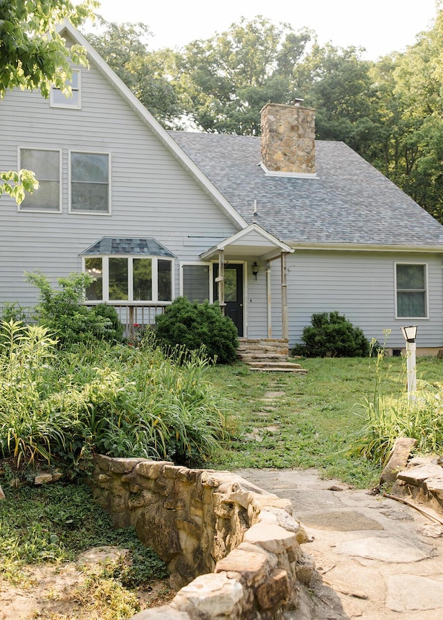 19429 E State Highway 14, Ava, MO 65608 - view of front of house featuring a shingled roof, a chimney, and a front yard