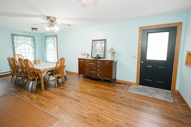 19429 E State Highway 14, Ava, MO 65608 - dining room with light wood-style floors, baseboards, a ceiling fan, and baseboard heating
