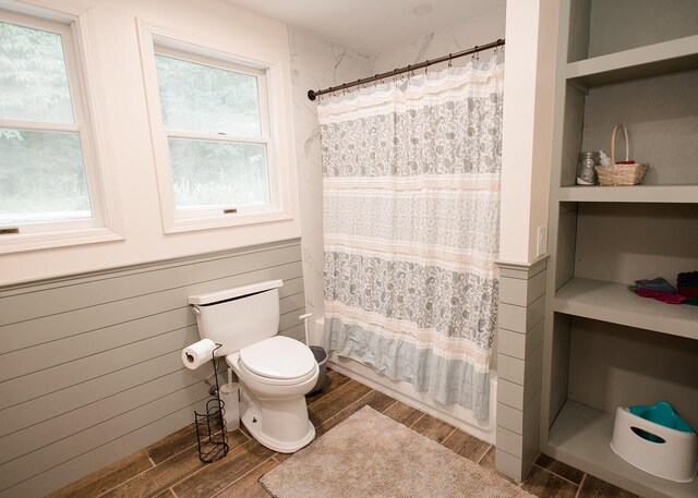 19429 E State Highway 14, Ava, MO 65608 - full bathroom with wood finished floors, toilet, shower / bath combination with curtain, and wainscoting