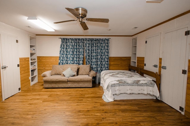 19429 E State Highway 14, Ava, MO 65608 - bedroom featuring wood walls, ornamental molding, wood finished floors, ceiling fan, and a wainscoted wall