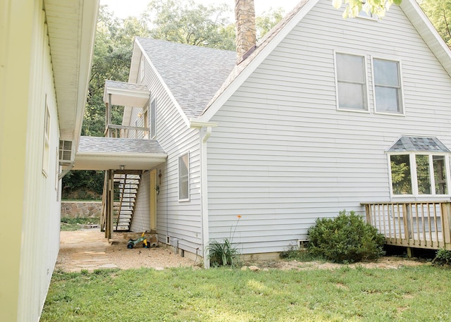19429 E State Highway 14, Ava, MO 65608 - view of home's exterior with roof with shingles, a deck, a chimney, and a yard