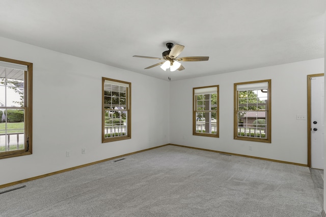 1605 S Meadowview Ave, Springfield, MO 65804 - spare room featuring baseboards, a ceiling fan, and light colored carpet