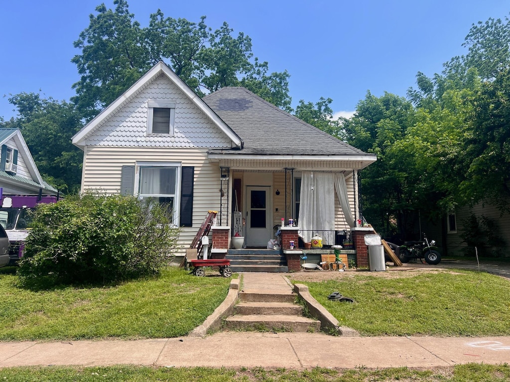 733 W Brower St, Springfield, MO 65802 - view of front of home featuring a porch and a front lawn