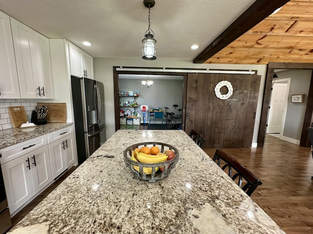 923 Riverview Rd, Marshfield, MO 65706 - kitchen featuring stainless steel refrigerator with ice dispenser, backsplash, white cabinets, dark wood-type flooring, and beamed ceiling