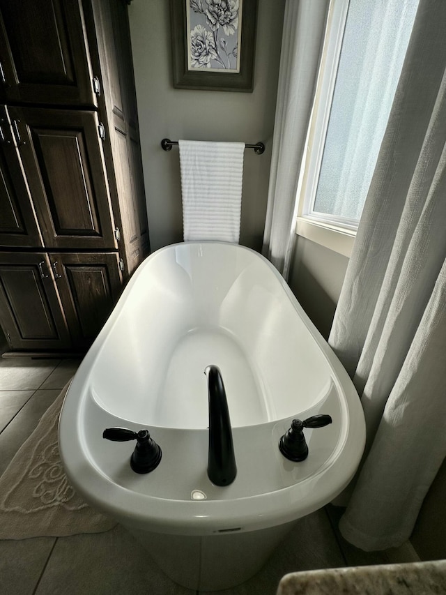 923 Riverview Rd, Marshfield, MO 65706 - bathroom featuring a freestanding tub and tile patterned flooring
